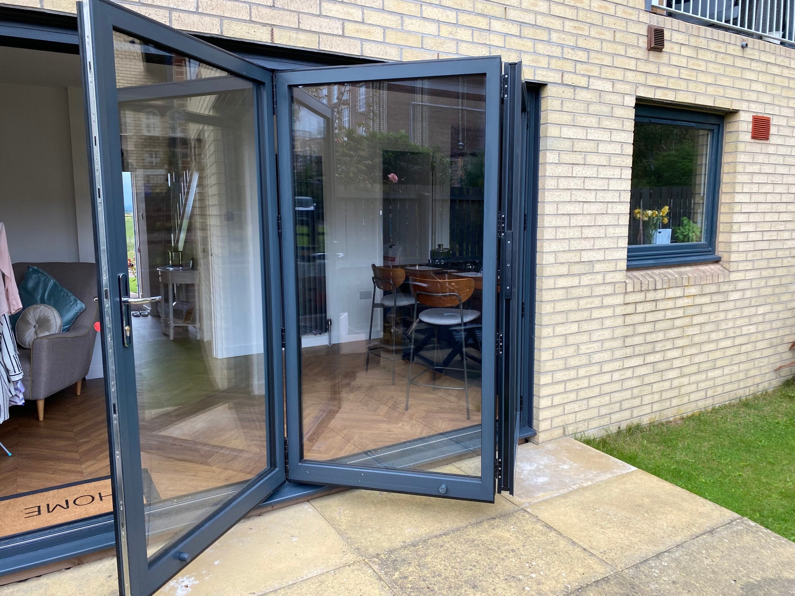 Aluminium bifold doors open at the rear of a home