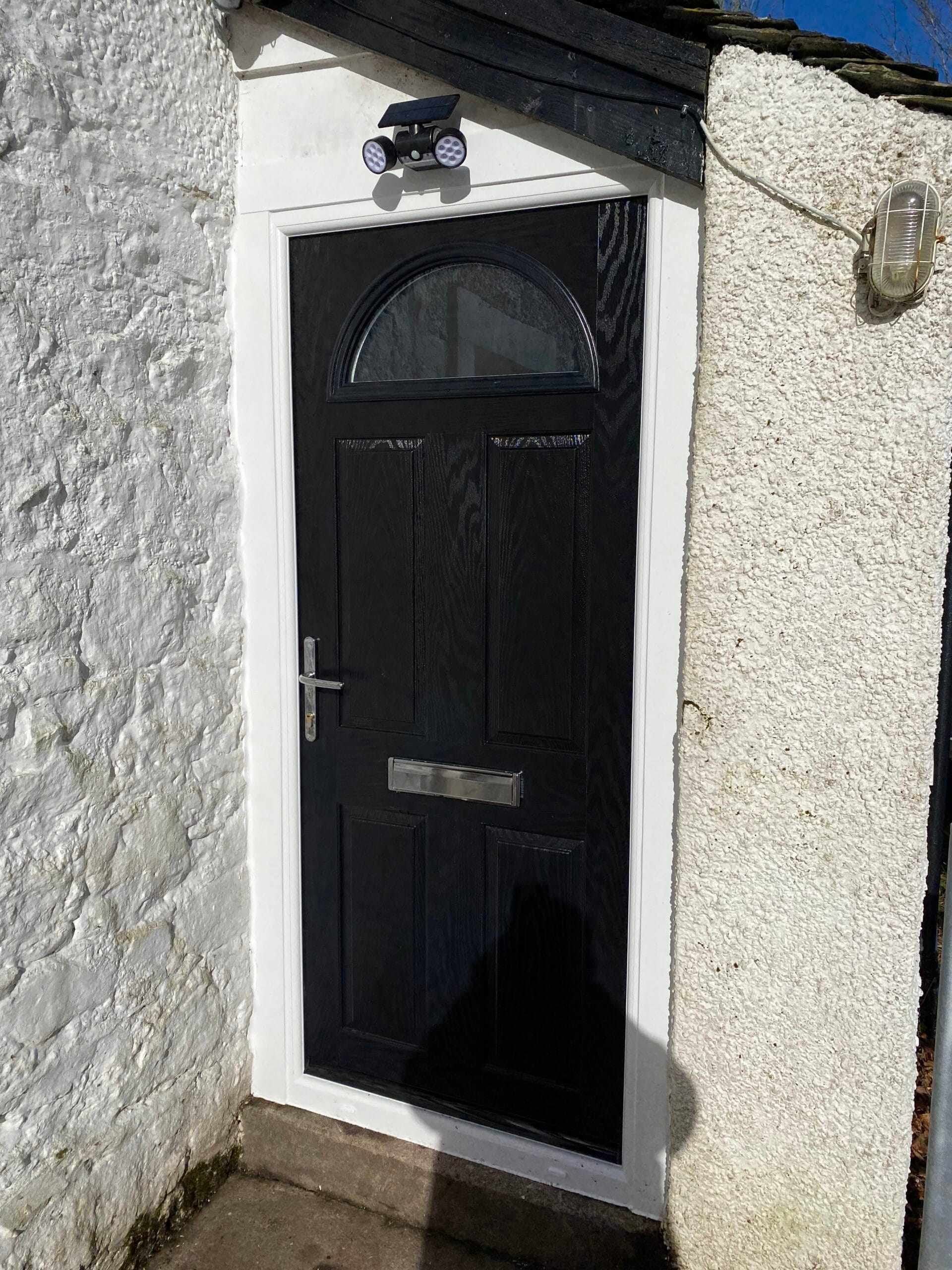 Black composite door installation on a Glasgow property