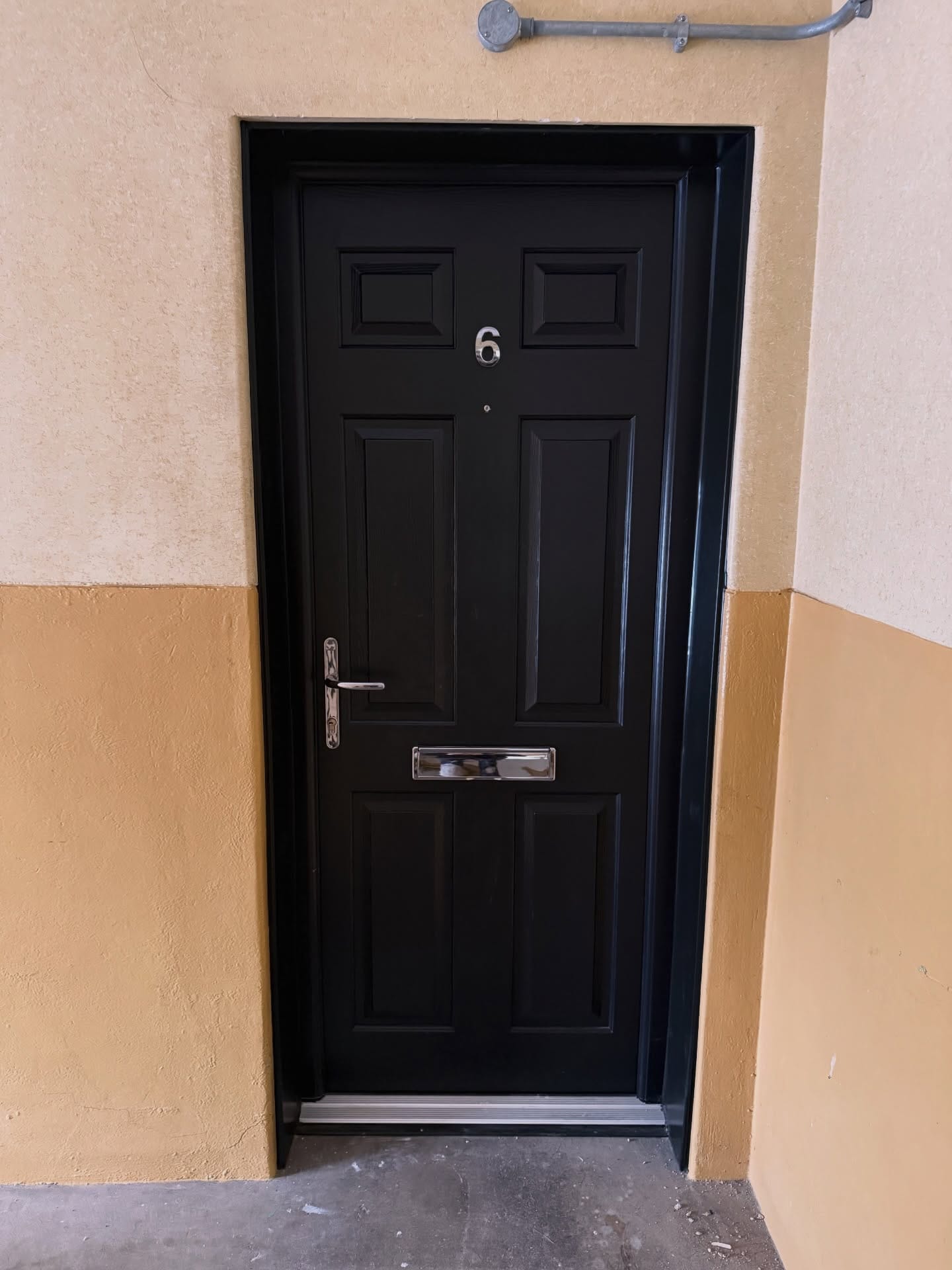 Composite fire door installed in a Glasgow tenement close