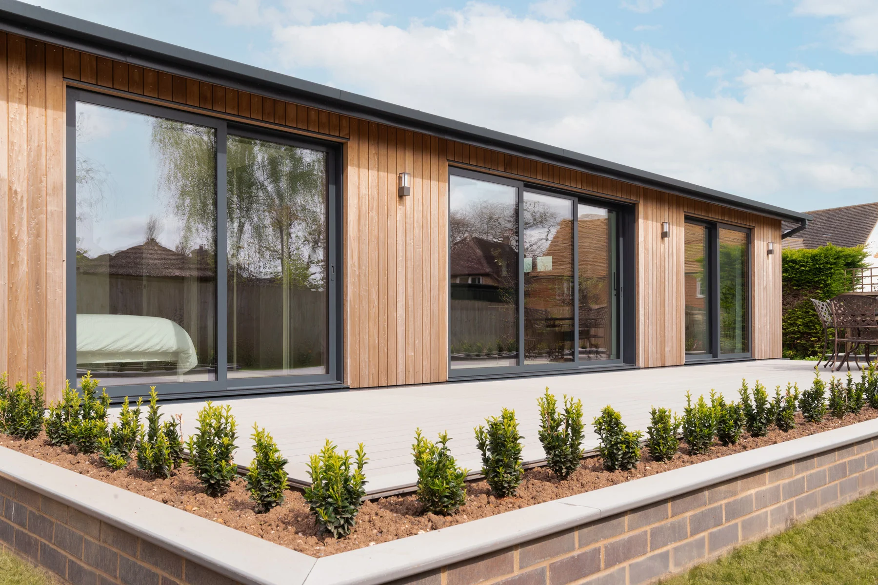 Sheerline grey aluminium sliding patio doors on a garden room