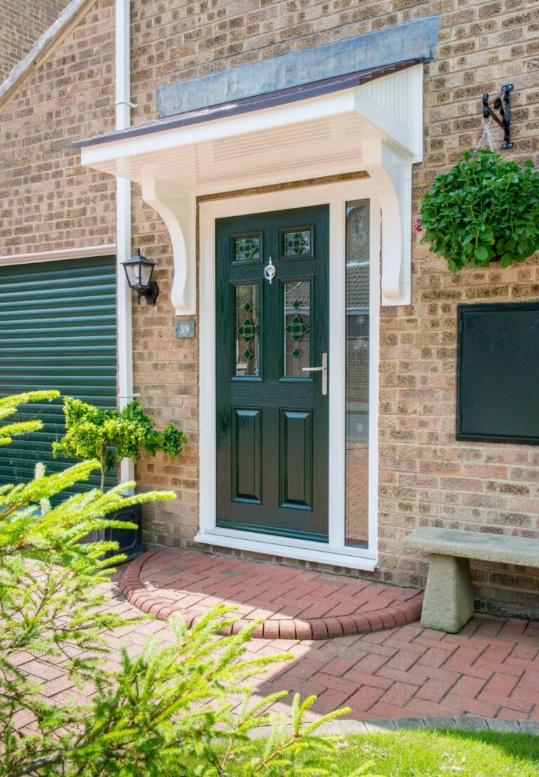 Green uPVC front door with decorative glass on a brick home
