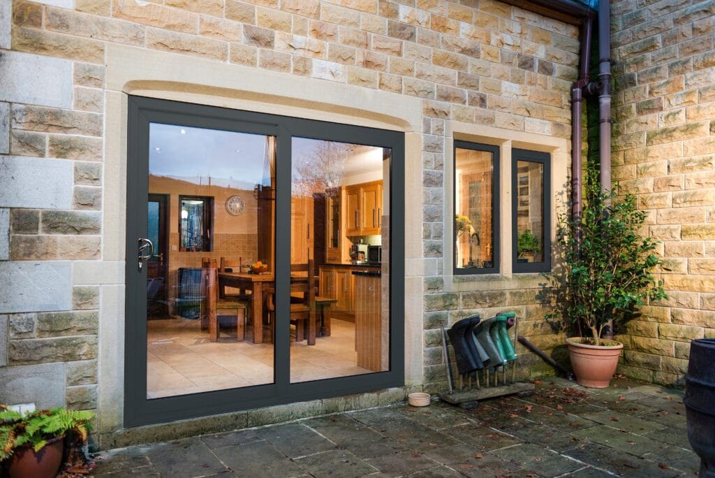 Anthracite grey sliding patio doors on a stone-built home